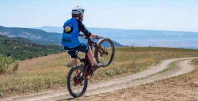 optibike-r17-wheelie-close Optibike R17 E-Bike doing a wheelie down a dirt road